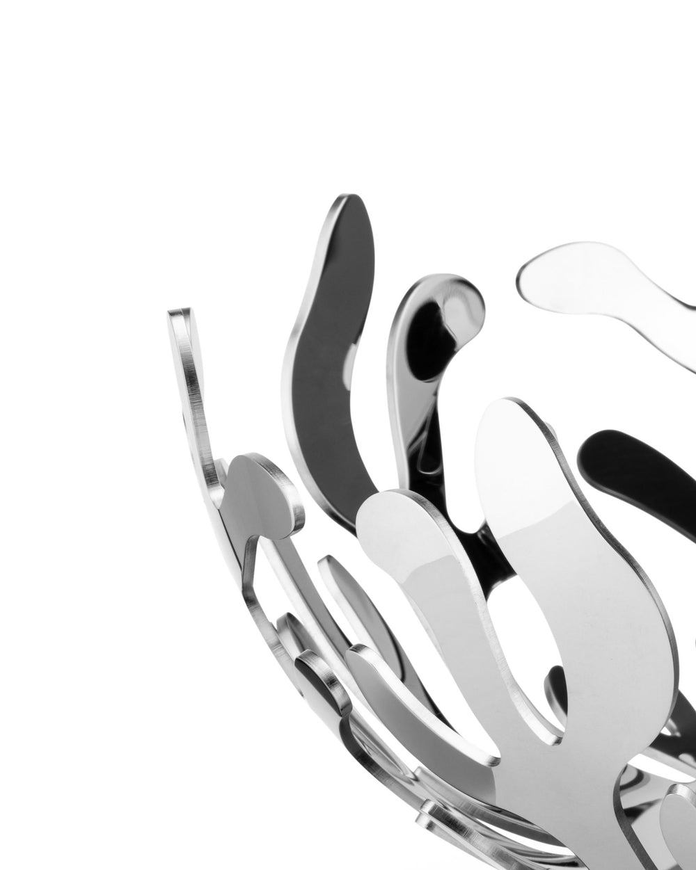 Silver sculptural bowl by Alessi with polished and brushed metal, featuring wave-like cutouts.