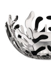 Silver metallic tealight holder by Alessi with intricate organic coral cutouts, holding a white candle.