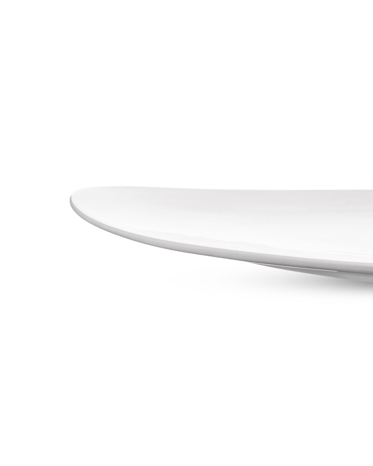 White serving plate by Alessi with a smooth, curved edge.