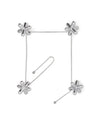 Silver metallic tripod trivet by Alessi, with four jack-shaped pieces linked by thin chains forming a square, plus an extra chain.