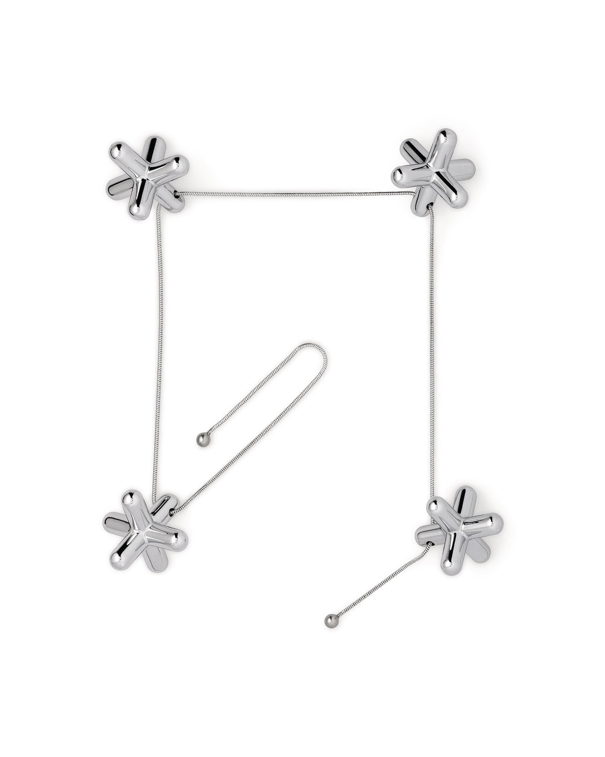 Silver metallic tripod trivet by Alessi, with four jack-shaped pieces linked by thin chains forming a square, plus an extra chain.