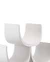 White modular wine rack by Alessi, featuring curved, interlocking sections in a close-up view.