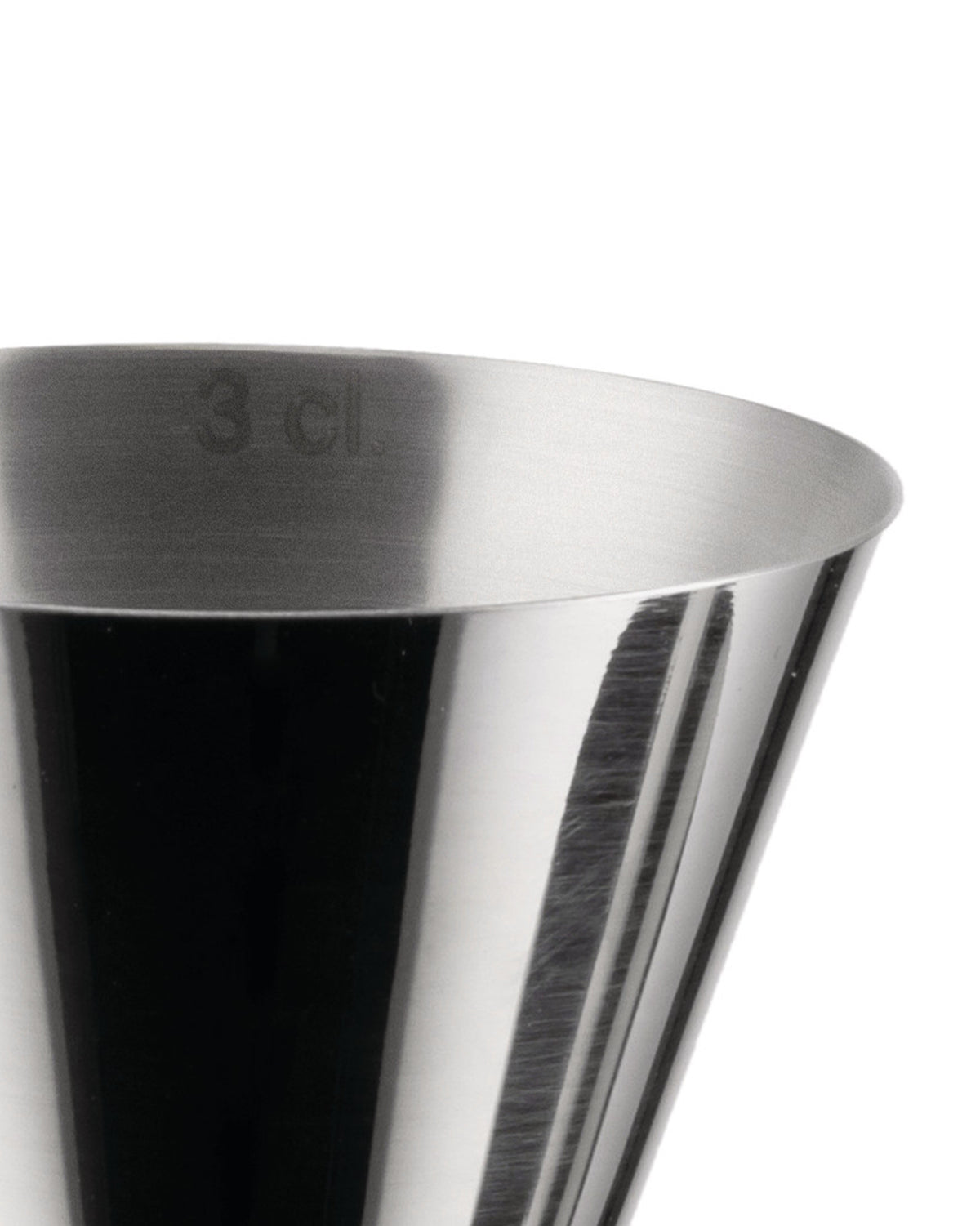 Close-up of a silver metallic jigger by Alessi with '3 cl' marking and reflective, brushed texture.