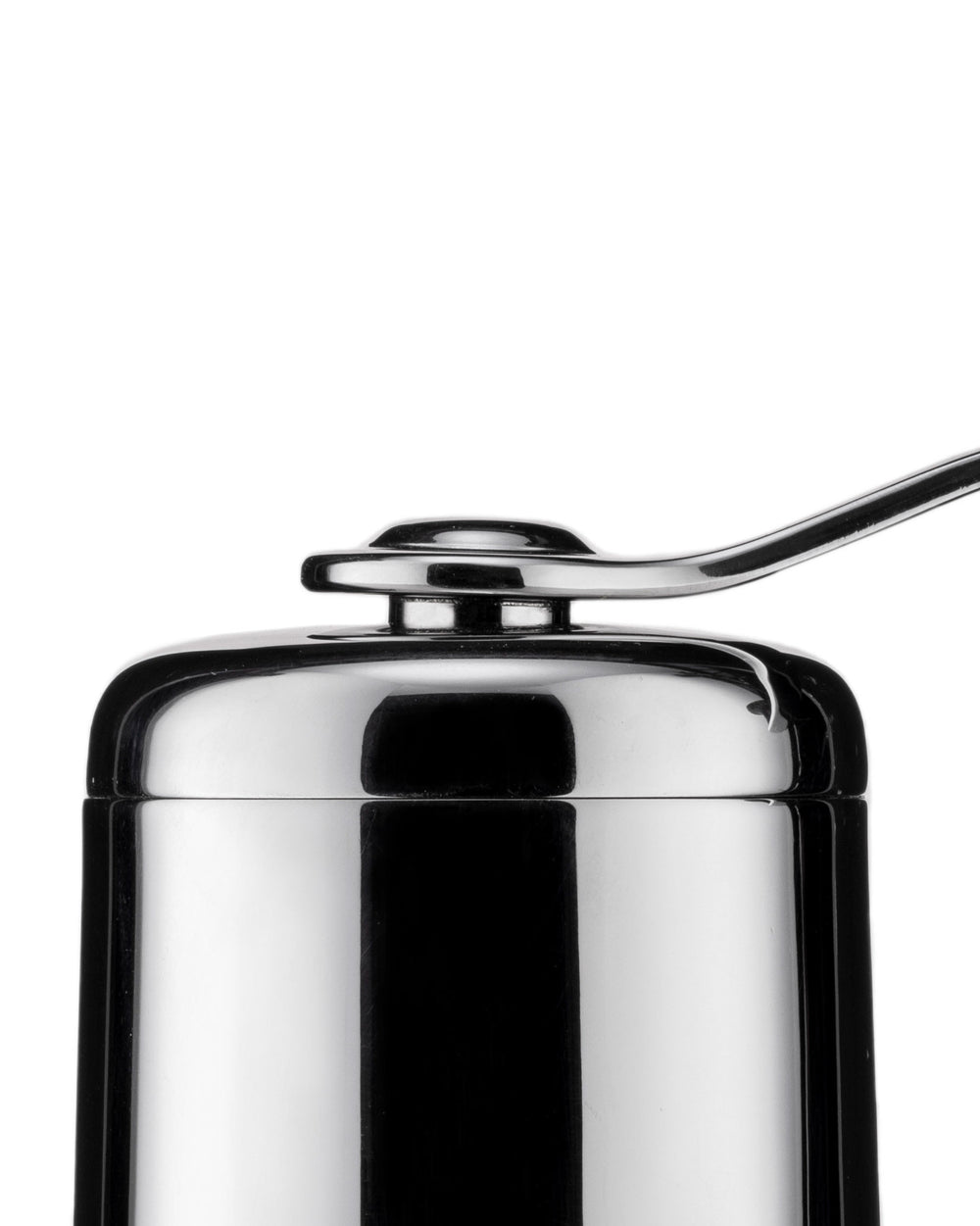 Chrome coffee grinder by Alessi with a sleek, metallic handle on top, cropped view.