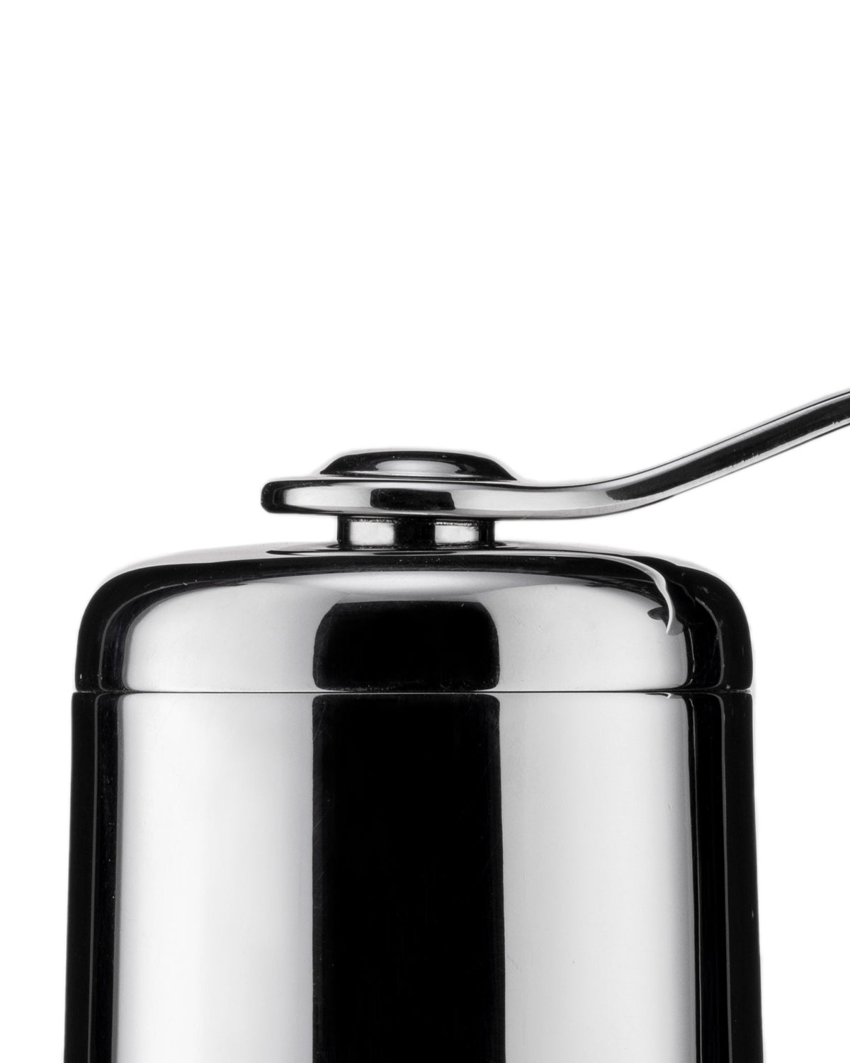 Chrome coffee grinder by Alessi with a sleek, metallic handle on top, cropped view.