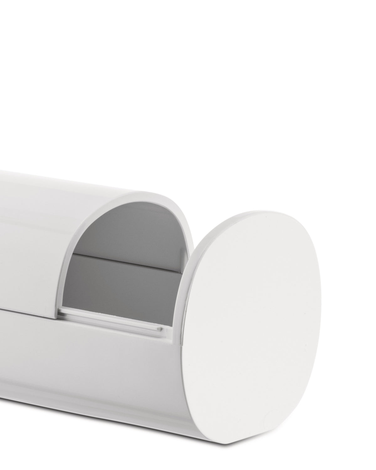 White storage container by Alessi, with a curved lid, open front, and smooth, glossy finish.