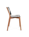 Modern chair with a shiny silver seat and wooden frame by Alessi, captured from a side view.