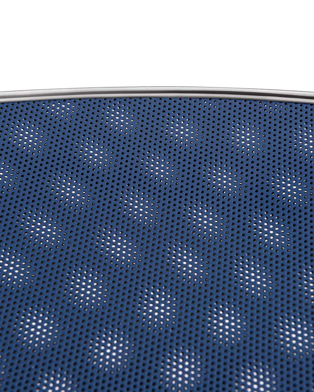 Blue Cohncave by Alessi, a perforated bowl with a silver metallic rim, revealing a white background through its small holes.