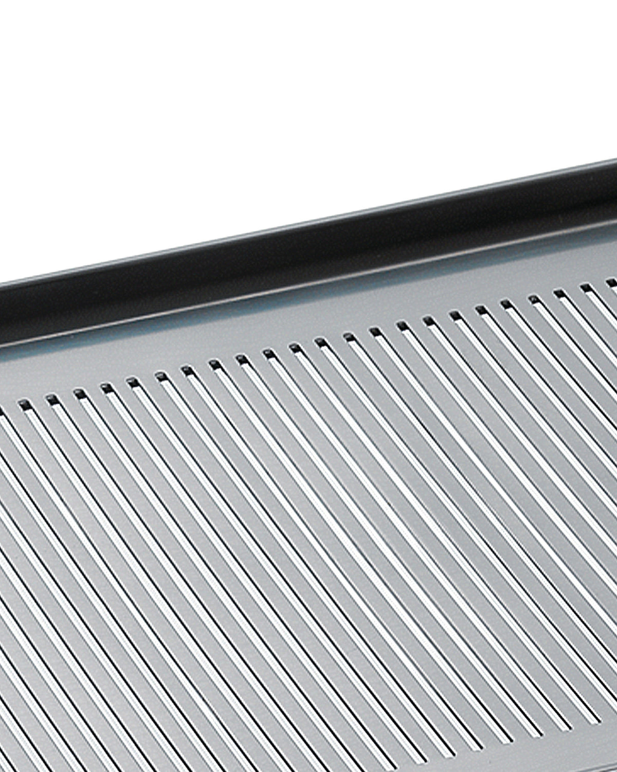 Silver-toned metal grate by Alessi featuring narrow parallel slits and a dark top edge, viewed from an angle.