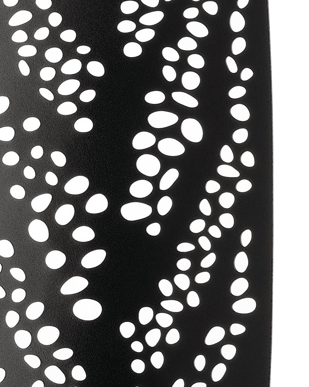 Black perforated decorative object by Alessi with flowing white oval cutouts and a matte texture, curving upward.