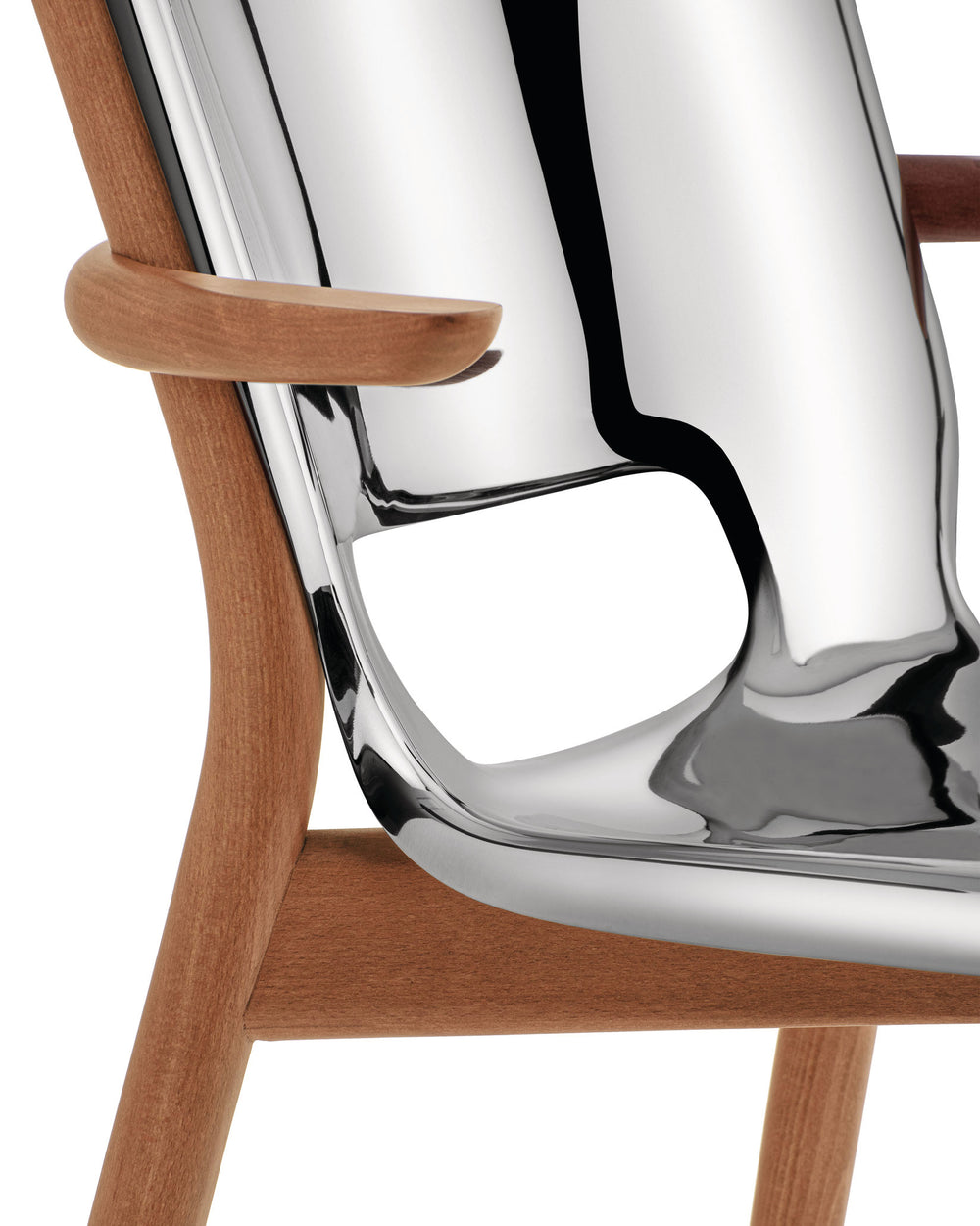 Curved wooden chair with a polished chrome seat by Alessi, featuring a sculptural cutout and smooth armrest in a close-up.