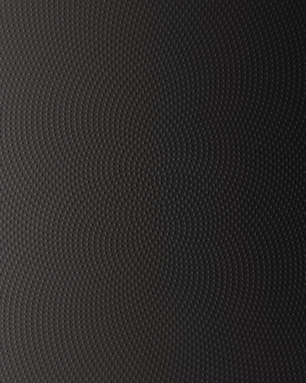 Dark gray moiré patterned surface by Alessi, featuring a wavy raised dot texture.