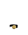 Black napkin ring by Alessi with a textured gold dimpled disc detail.