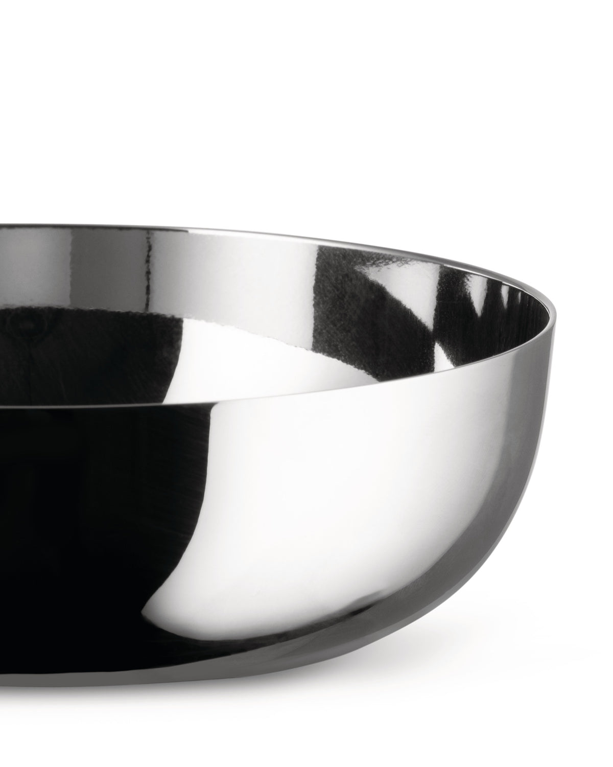 Silver metallic bowl by Alessi, cropped, reflecting abstract dark and white patterns.