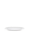White oval plate by Alessi with a subtle raised rim, shown at a low angle.