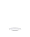 White ceramic plate by Alessi, simple and round, seen from a low, slightly angled perspective.