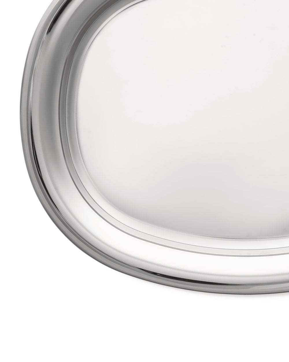 Silver oval serving tray by Alessi, a close-up showing its highly reflective surface and raised edge.