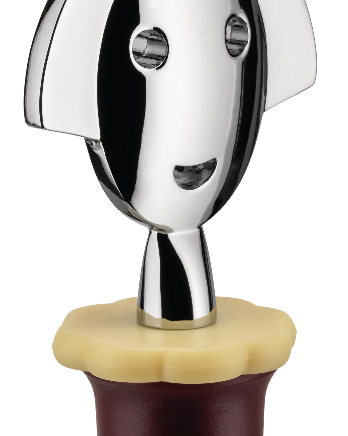 Chrome bottle stopper with a stylized smiling face by Alessi, featuring a yellow wavy base partially inserted into a dark bottle.