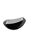 Black curved stainless steel grater by Alessi with a finely perforated grating surface on a white background.