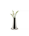 Shiny silver trumpet vase by Alessi holding white freesia flowers on a white background.