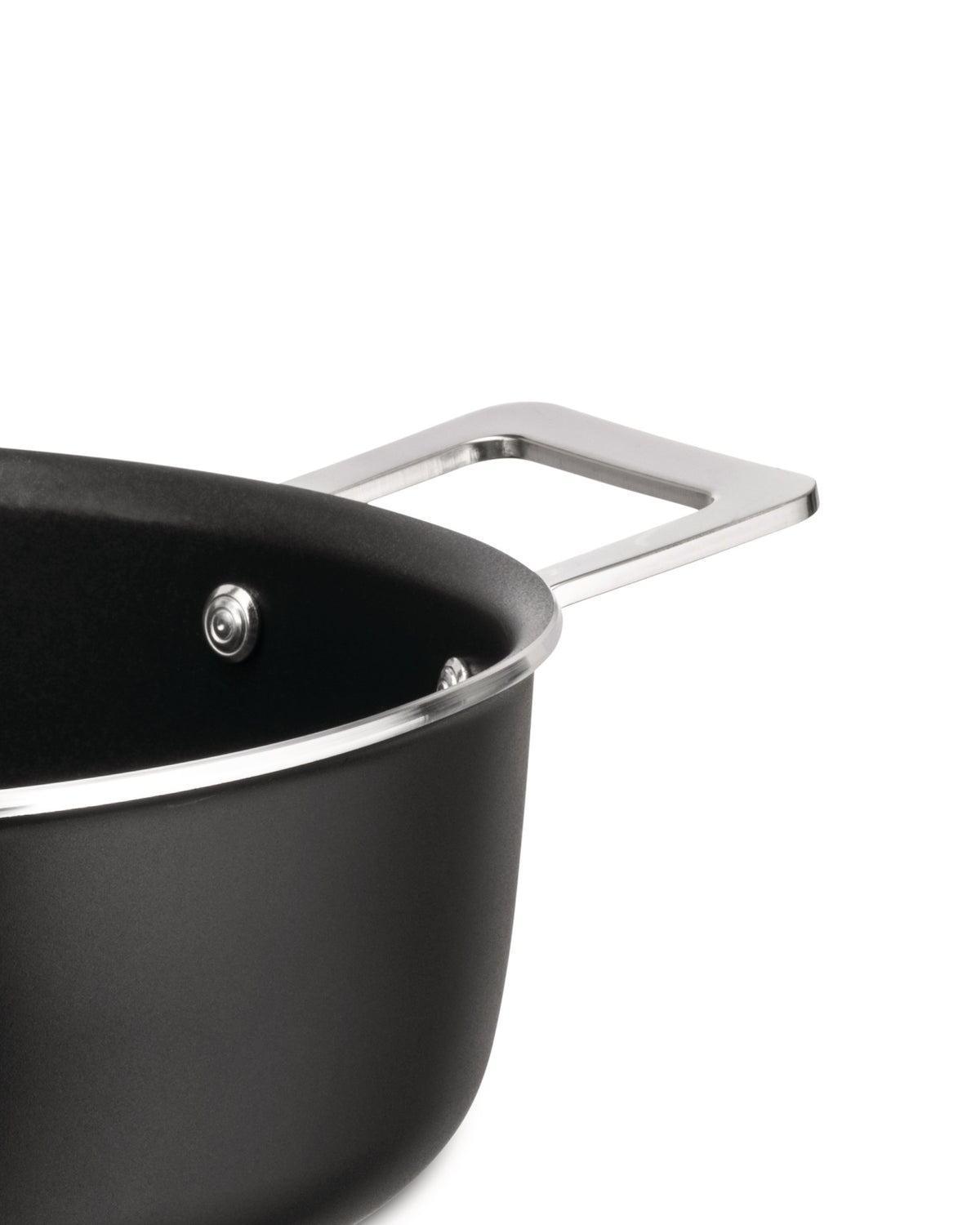 Black casserole by Alessi with a matte finish, polished silver handles and rim, shown in a close-up.