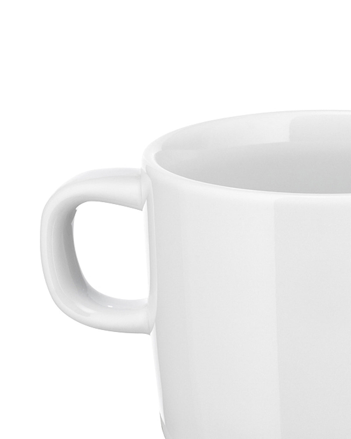 White ceramic mug by Alessi, a cropped side view showing the handle and upper rim.