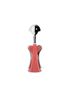 Pink and silver Anna G. corkscrew by Alessi with a smiling face and a pleated skirt-like body on a white background.