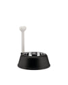 Black pet bowl with a stainless steel insert by Alessi, featuring a tall white bone-shaped handle.