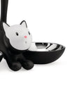 Black and white cat-shaped pet feeder by Alessi with a shiny metal bowl.