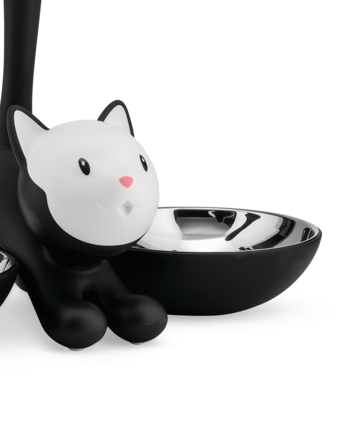 Black and white cat-shaped pet feeder by Alessi with a shiny metal bowl.