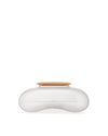 Frosted white biscuit box by Alessi with a tan biscuit-shaped, ribbed lid, side view.