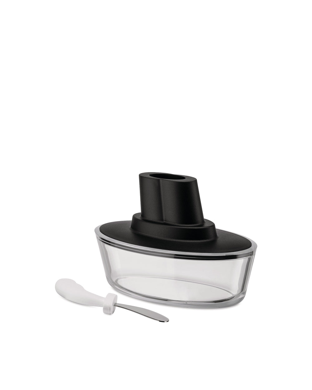 Clear glass and black Ship-shaped butter dish by Alessi, shown with a white-handled spreader.