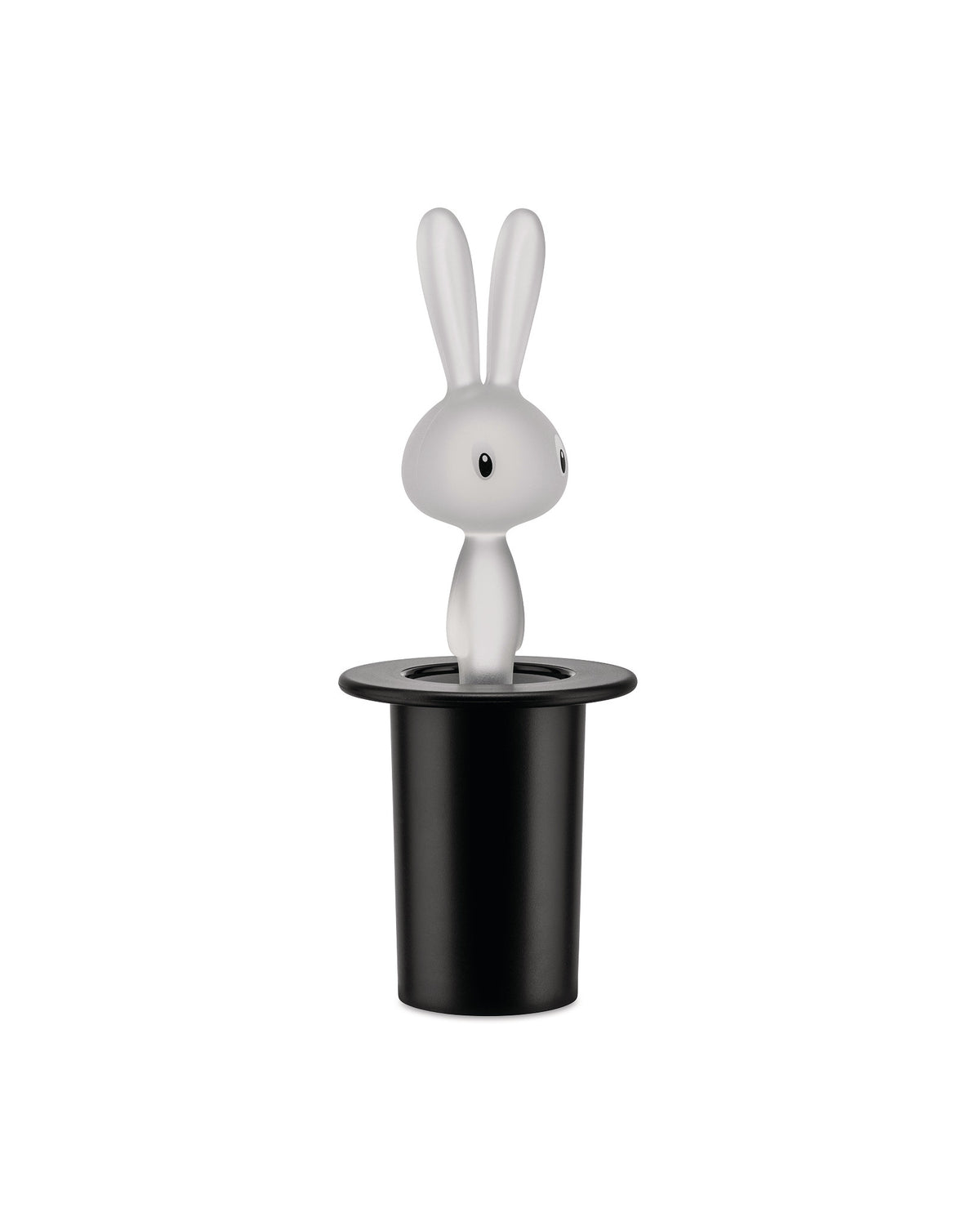 White translucent rabbit figurine by Alessi, with black eyes and long ears, emerging from a matte black top hat.