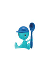 Translucent turquoise character egg cup with blue hat and matching spoon by Alessi, shown sitting.