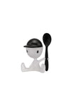 White and black plastic Cico egg cup by Alessi, styled as a sitting person wearing a black cap and holding a black spoon.
