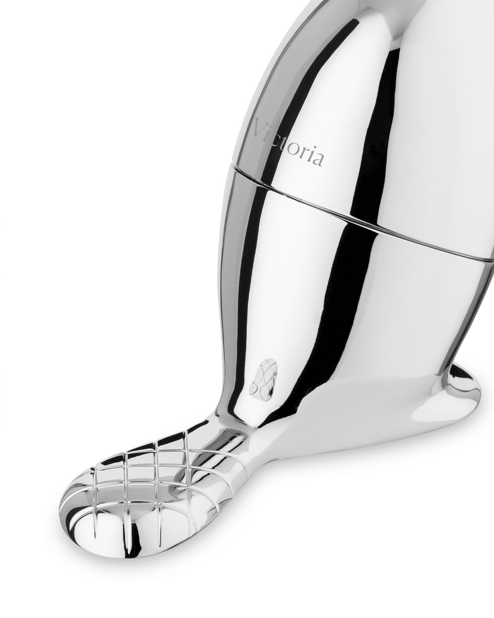 Angled view of a chrome-plated beaver-shaped object by Alessi, featuring 'Victoria' text, a shoe icon, and a grid-patterned tail.