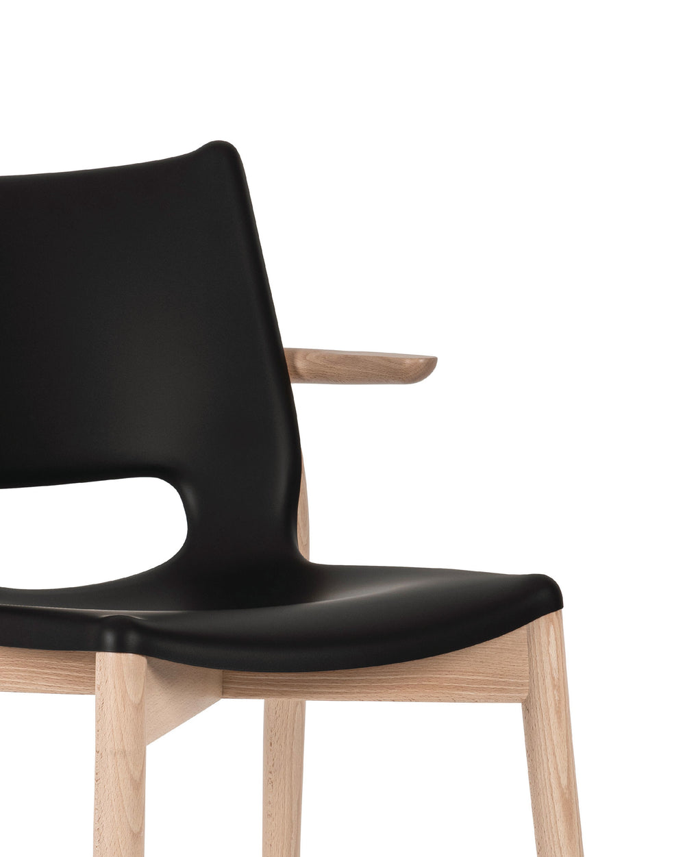 Black contoured chair with natural wood frame by Alessi, featuring an integrated short wooden armrest.