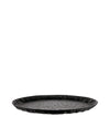 Black oval tray by Alessi, featuring a faceted geometric pattern, shown at a slight angle.
