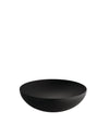Black bowl by Alessi with a textured interior and smooth exterior, presented at an angle.
