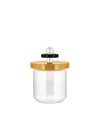 Clear glass jar by Alessi with a gold lid, black accent, and white spherical handle.