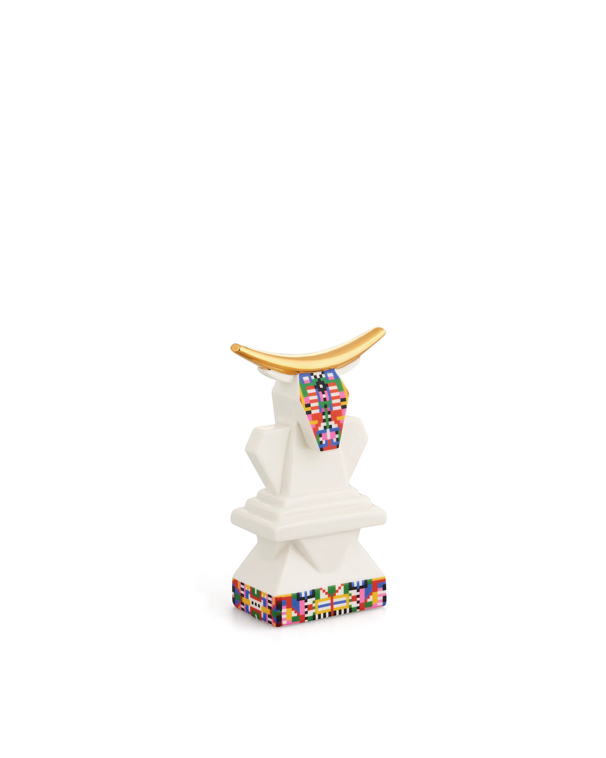 White cow sculpture with golden horns by Alessi, adorned with colorful pixelated patterns on its chest and base.