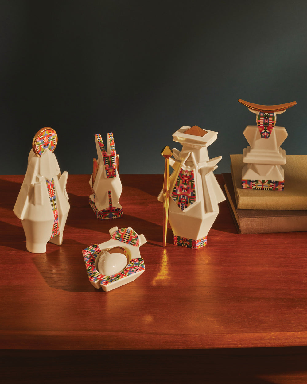 White geometric donkey figurine by Alessi, with colorful pixelated patterns, on a wooden table.