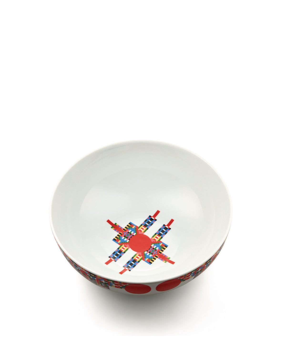 White bowl by Alessi with a pixelated, colorful star-like design inside and red dots on the outer rim.