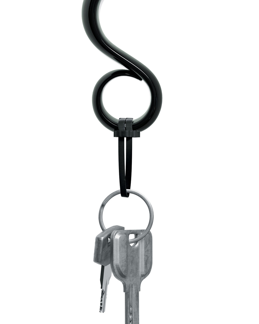 Black S-shaped key holder by Alessi, holding two silver keys on a metal ring, secured by a black fastener.
