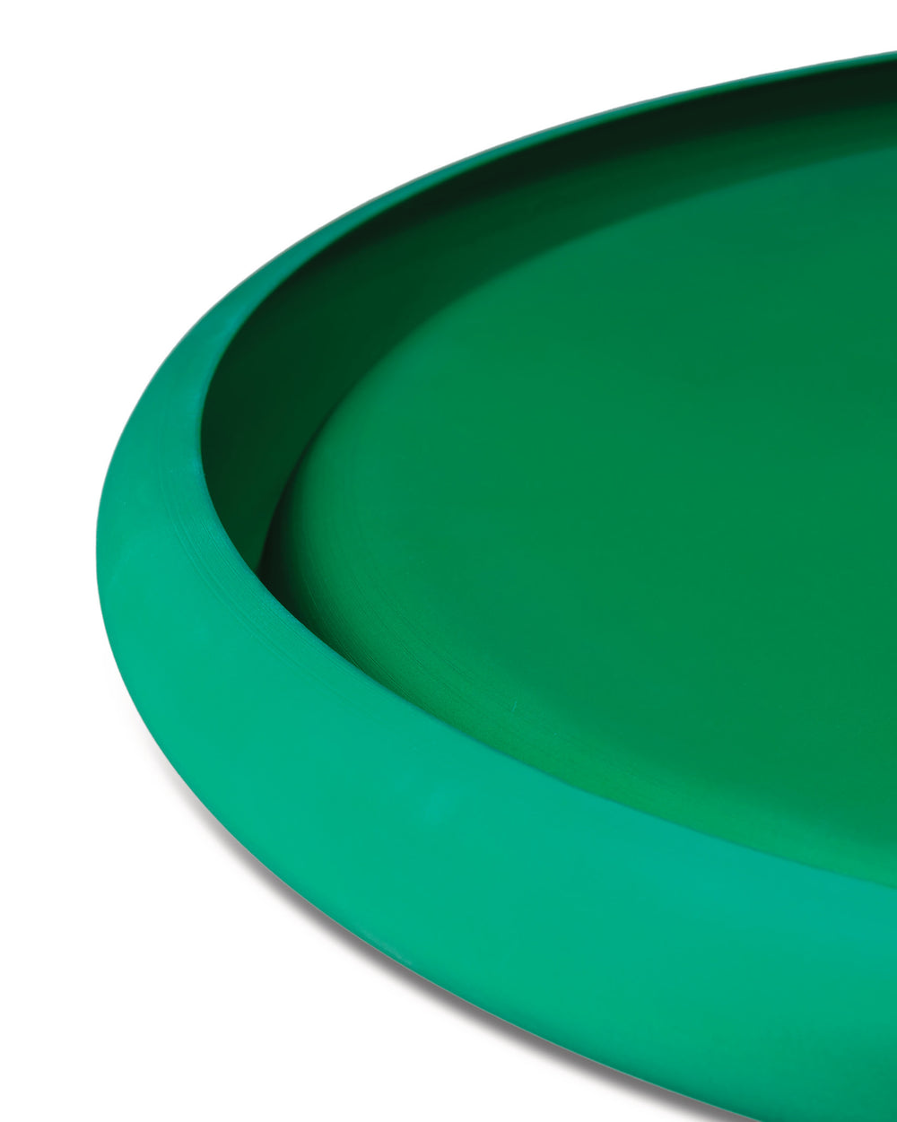 Emerald green bowl by Alessi with a smooth, subtly textured finish and curved rim.
