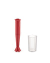 Red pleated hand blender by Alessi, standing next to a clear ribbed measuring cup.