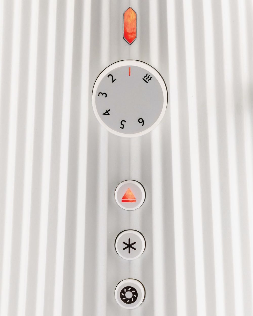White ridged toaster by Alessi with a close-up of the control dial, orange indicator, and function buttons including cancel, defrost, and bagel.