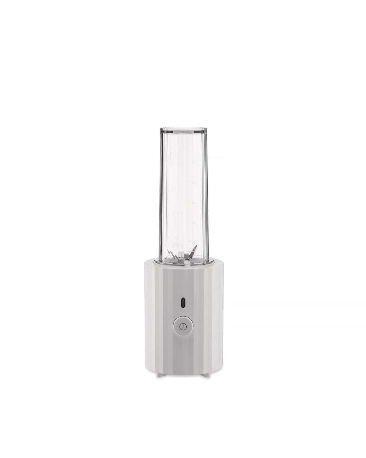 White portable blender by Alessi with a clear ribbed cup and a faceted base featuring a power button.
