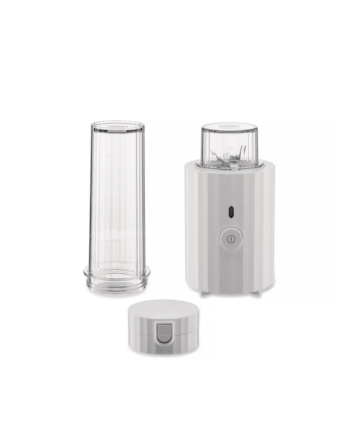 White ribbed blender by Alessi with a clear blending cup, a separate travel cup, and a matching lid.