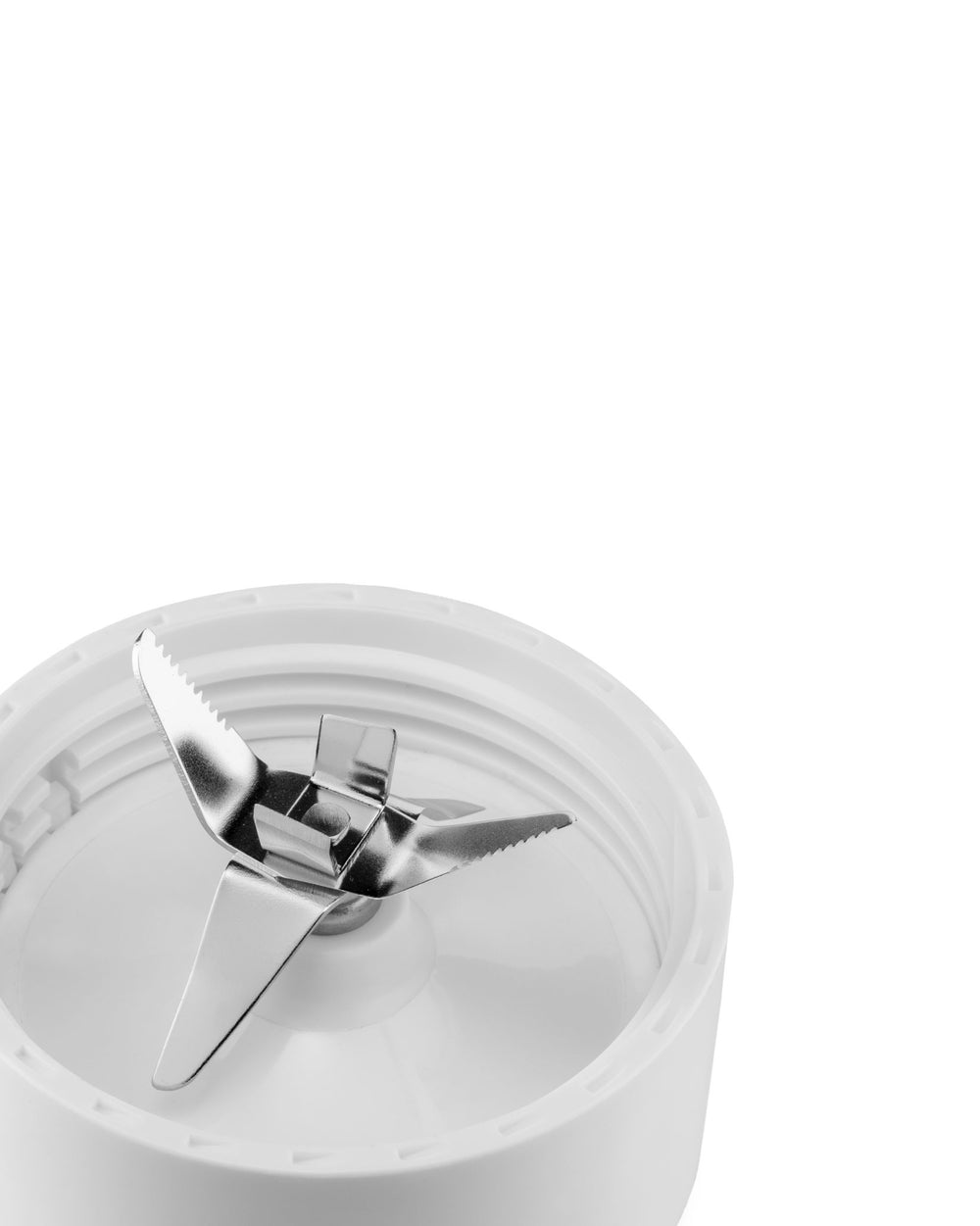 White blender by Alessi, showing its four metallic blades, two serrated, set in a white base.
